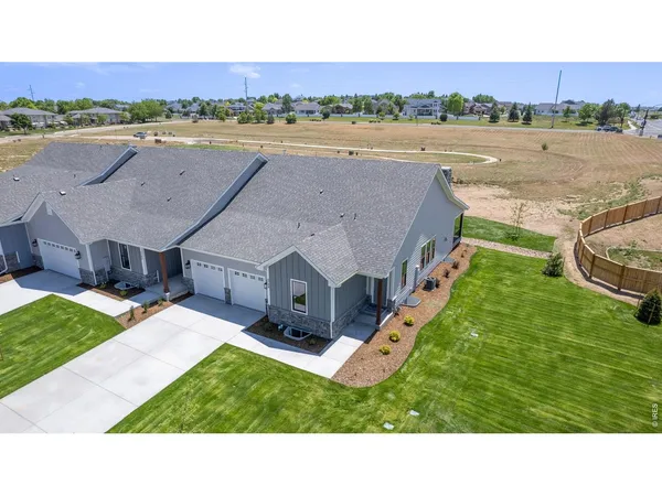 a aerial view of a house with a yard and lake view