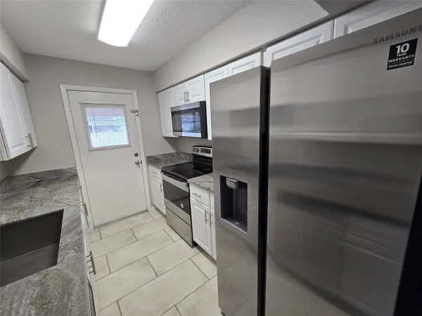 a kitchen with a refrigerator stove and oven