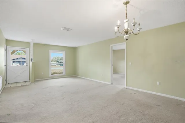 a view of a chandelier in big room and chandelier fan