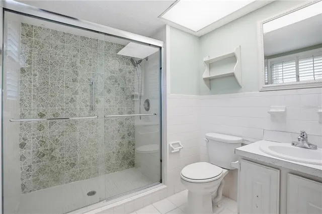 a bathroom with a shower toilet and sink