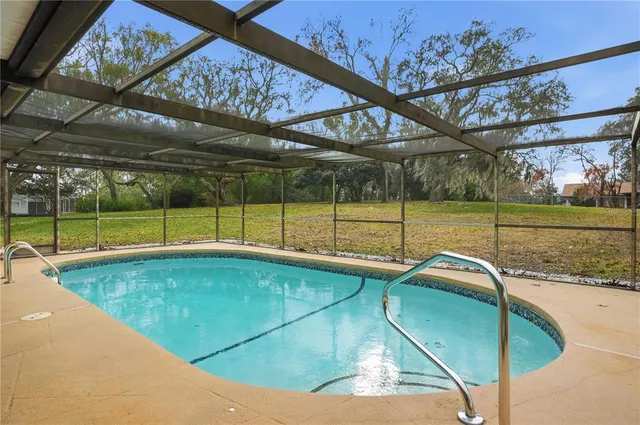 a view of a backyard with swimming pool