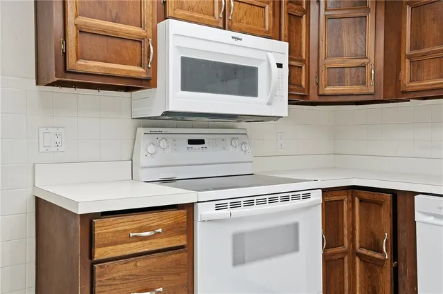 a kitchen with granite countertop cabinets stainless steel appliances and a counter space