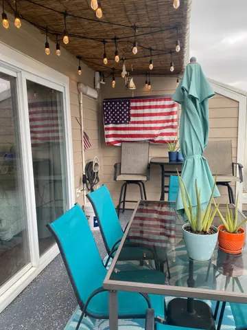 a view of a dining room with furniture and a potted plant