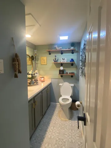 a bathroom with a sink a toilet and a mirror