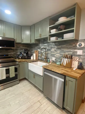 a kitchen with granite countertop a stove and a sink