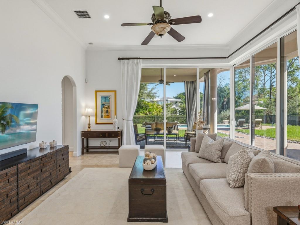 506 Ridge Drive Naples, FL 34108 - Photo 12 of 33 Living area featuring a ceiling fan, arched walkways, and ornamental molding