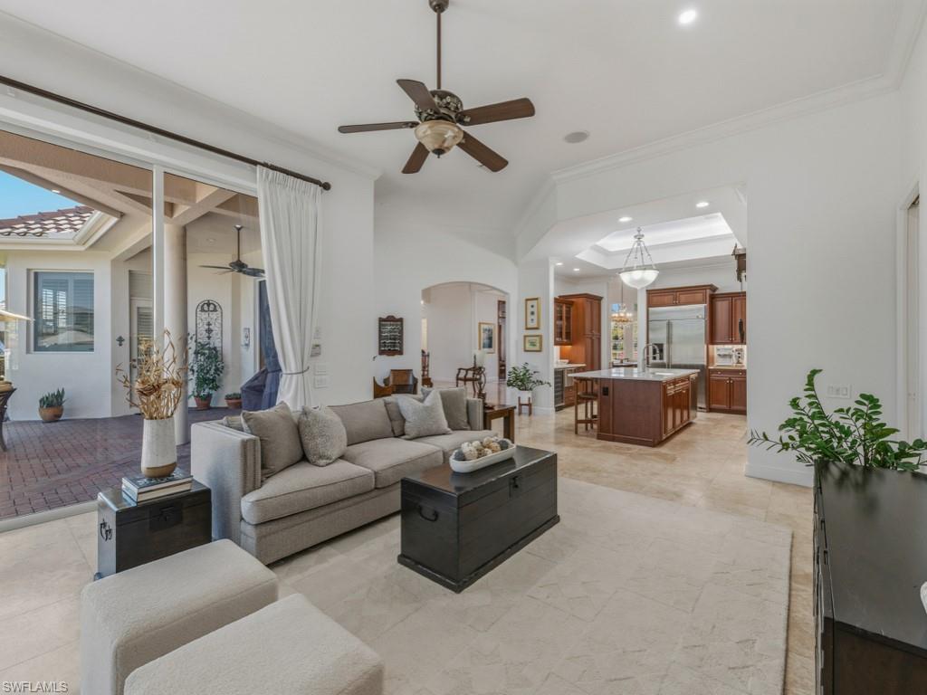 506 Ridge Drive Naples, FL 34108 - Photo 13 of 33 Living area featuring ceiling fan, arched walkways, ornamental molding, and recessed lighting