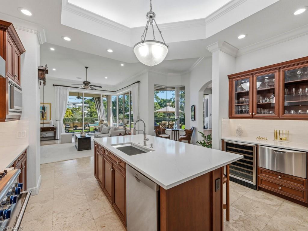 506 Ridge Drive Naples, FL 34108 - Photo 19 of 33 Kitchen with tasteful backsplash, glass insert cabinets, pendant lighting, beverage cooler, and recessed lighting
