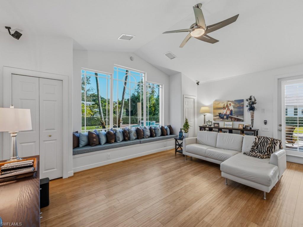 506 Ridge Drive Naples, FL 34108 - Photo 21 of 33 Living area featuring ceiling fan, light wood-type flooring, and lofted ceiling