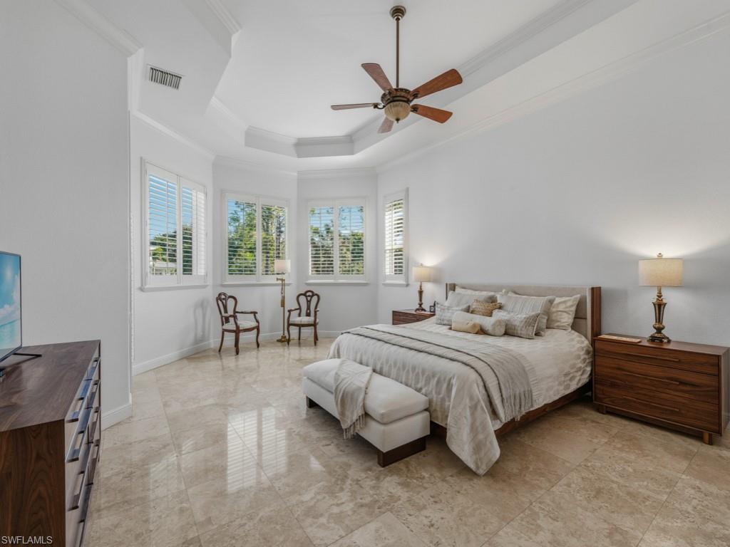 506 Ridge Drive Naples, FL 34108 - Photo 25 of 33 Bedroom featuring a tray ceiling, crown molding, and ceiling fan