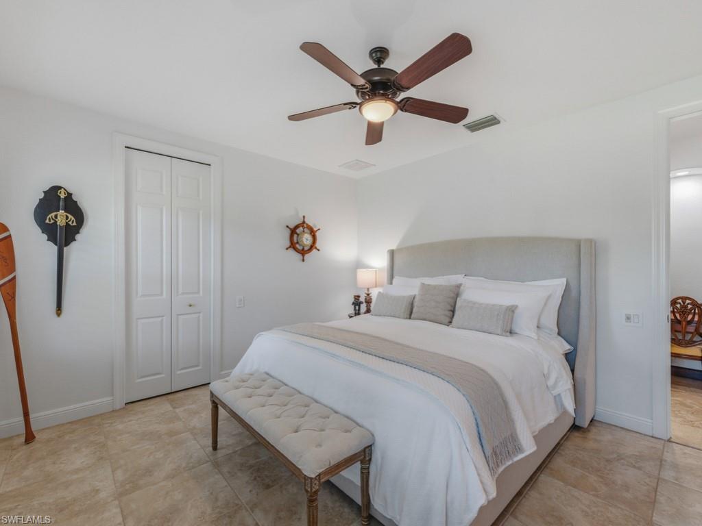 506 Ridge Drive Naples, FL 34108 - Photo 29 of 33 Bedroom with ceiling fan and a closet