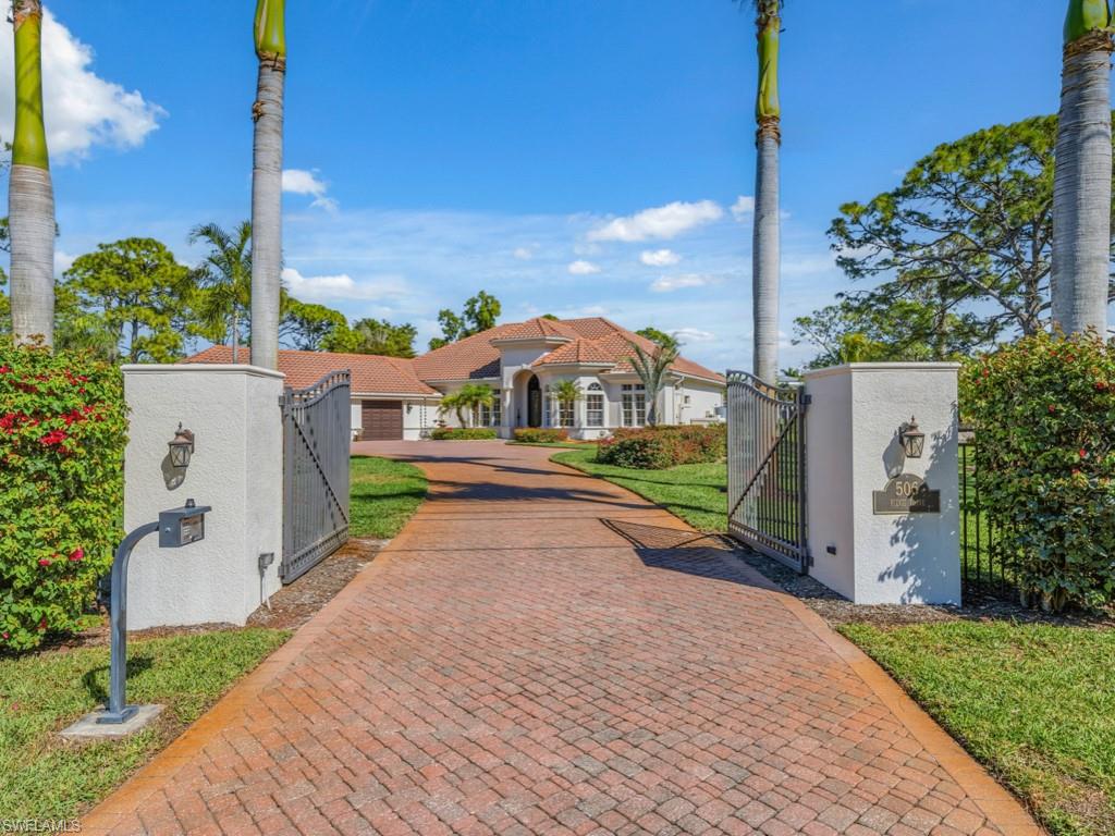 506 Ridge Drive Naples, FL 34108 - Photo 3 of 33 Mediterranean / spanish-style home featuring a gate, a fenced front yard, and stucco siding