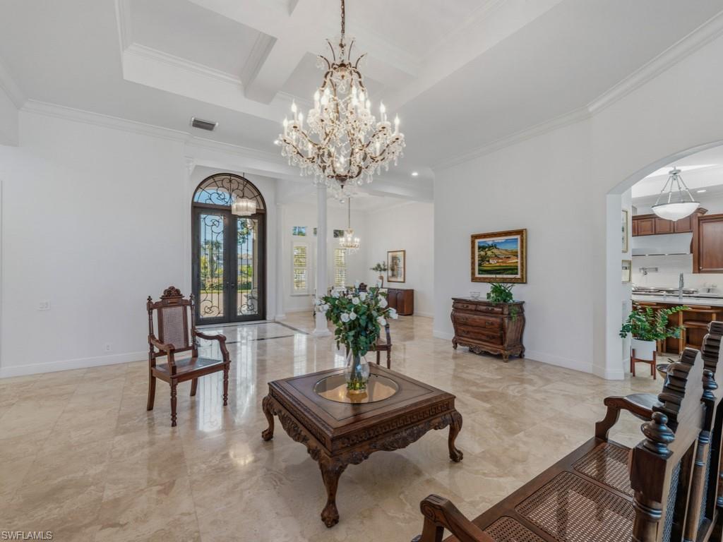 506 Ridge Drive Naples, FL 34108 - Photo 5 of 33 Living area featuring arched walkways, light marble finish flooring, french doors, coffered ceiling, and crown molding