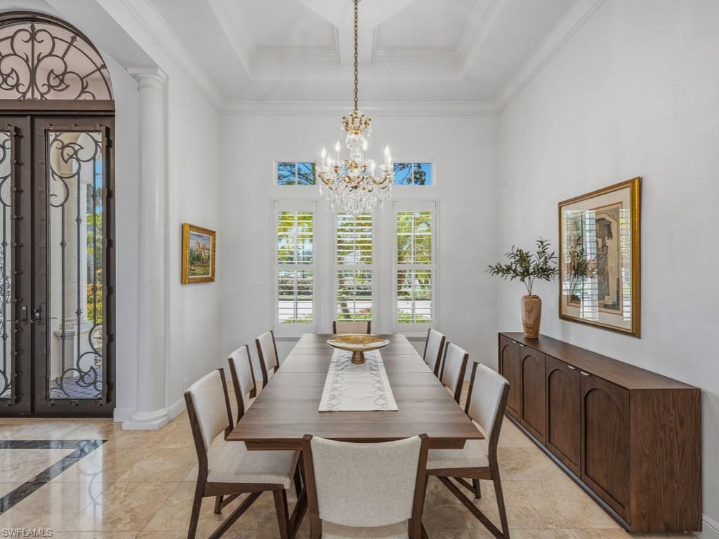 506 Ridge Drive Naples, FL 34108 - Photo 8 of 33 Dining space featuring ornate columns, a chandelier, french doors, and crown molding