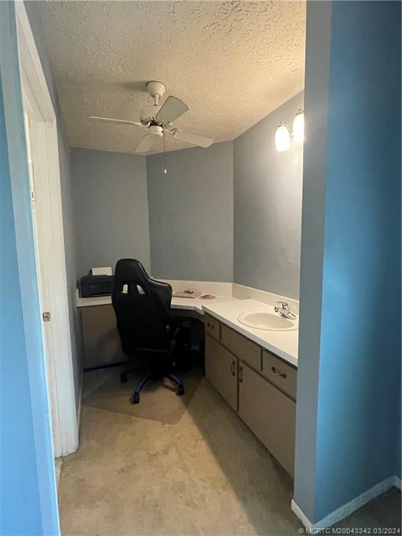 8552 Southwest 17th Avenue Stuart, FL 34997 - Photo 17 of 25 a view of a workspace with furniture and a window