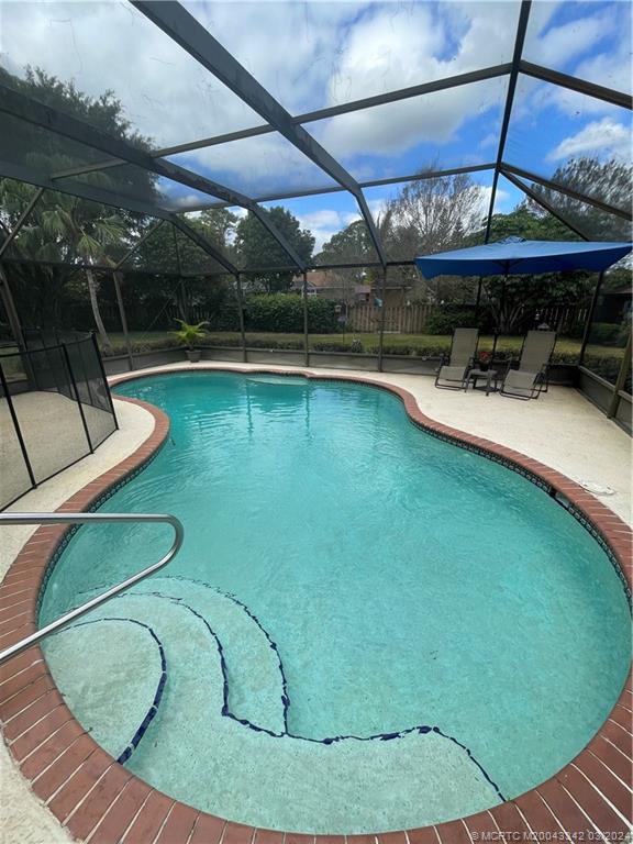 8552 Southwest 17th Avenue Stuart, FL 34997 - Photo 21 of 25 a view of a swimming pool with a yard and sitting area