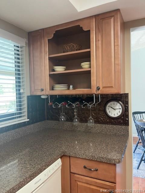 8552 Southwest 17th Avenue Stuart, FL 34997 - Photo 23 of 25 a kitchen with a granite countertop sink and cabinets