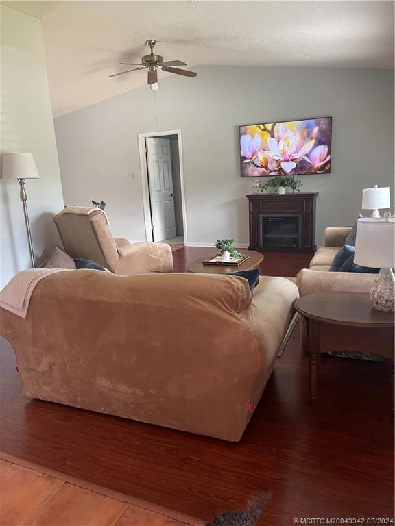 8552 Southwest 17th Avenue Stuart, FL 34997 - Photo 6 of 25 a living room with furniture and a fireplace