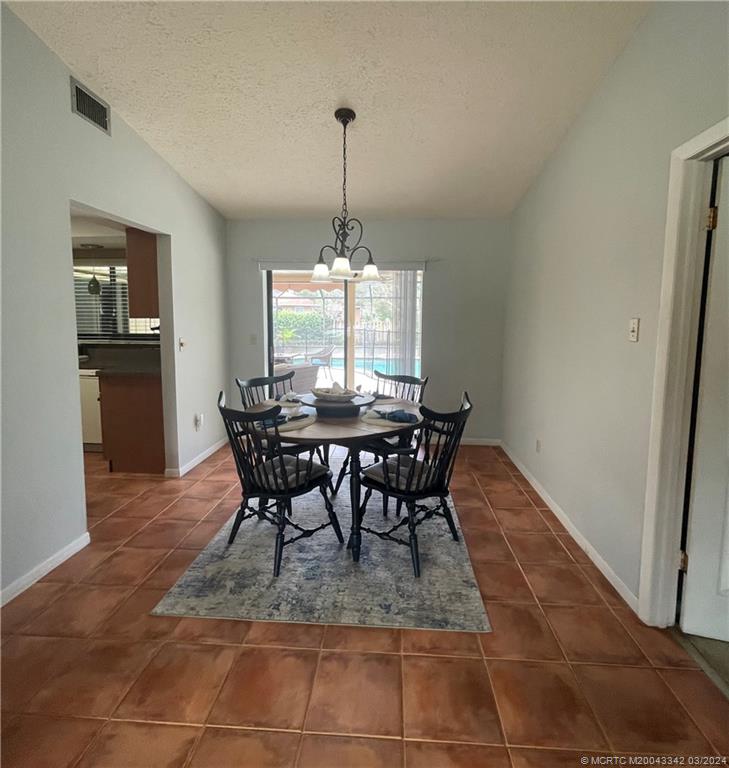 8552 Southwest 17th Avenue Stuart, FL 34997 - Photo 9 of 25 a view of a dining room with furniture and window