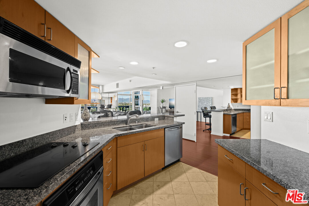 13700 Marina Pointe Drive, Unit 1007 Marina del Rey, CA 90292 - Photo 11 of 53 a kitchen with lots of counter top space and appliances