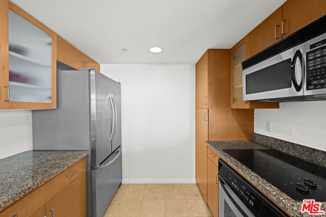 13700 Marina Pointe Drive, Unit 1007 Marina del Rey, CA 90292 - Photo 13 of 53 a kitchen with stainless steel appliances granite countertop a refrigerator and a sink