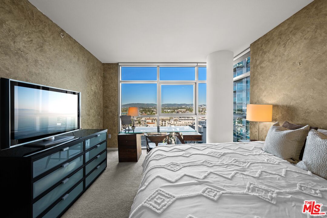 13700 Marina Pointe Drive, Unit 1007 Marina del Rey, CA 90292 - Photo 17 of 53 a bedroom with a bed and a flat screen tv