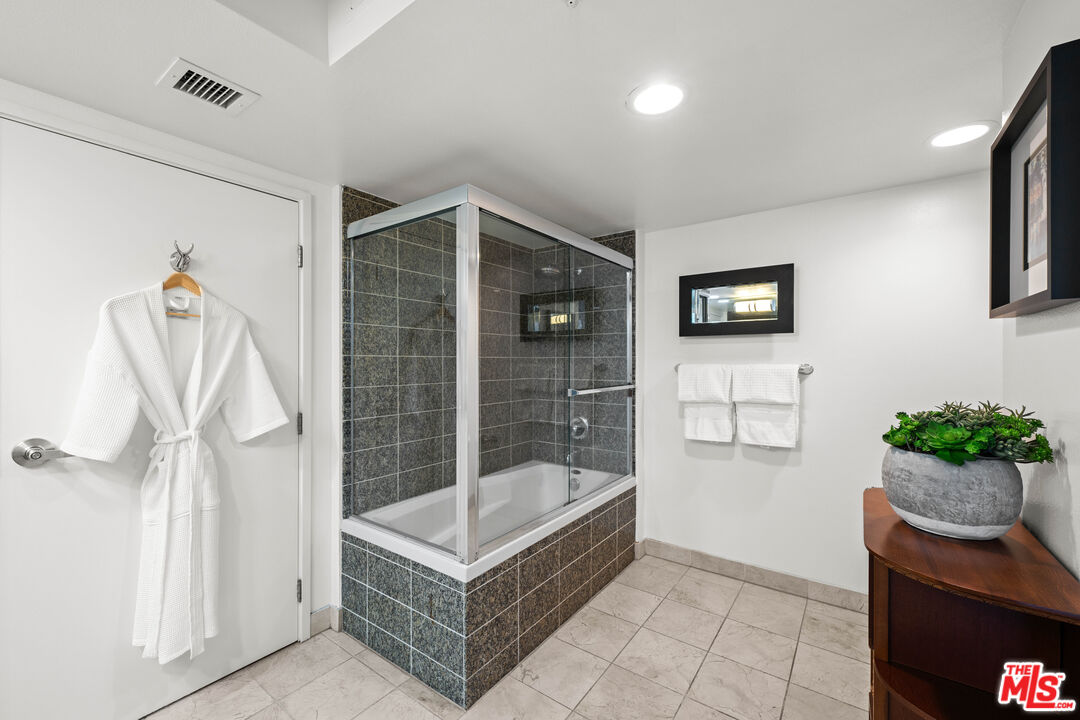 13700 Marina Pointe Drive, Unit 1007 Marina del Rey, CA 90292 - Photo 23 of 53 a bathroom with a tub and shower