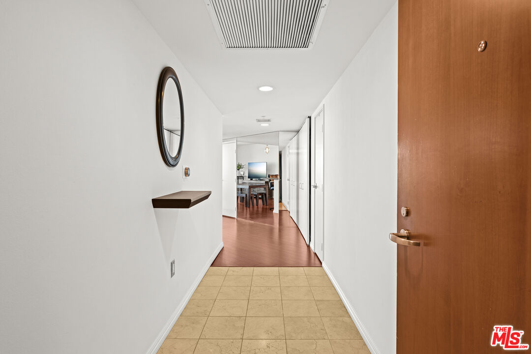13700 Marina Pointe Drive, Unit 1007 Marina del Rey, CA 90292 - Photo 27 of 53 a view of a hallway with wooden floor