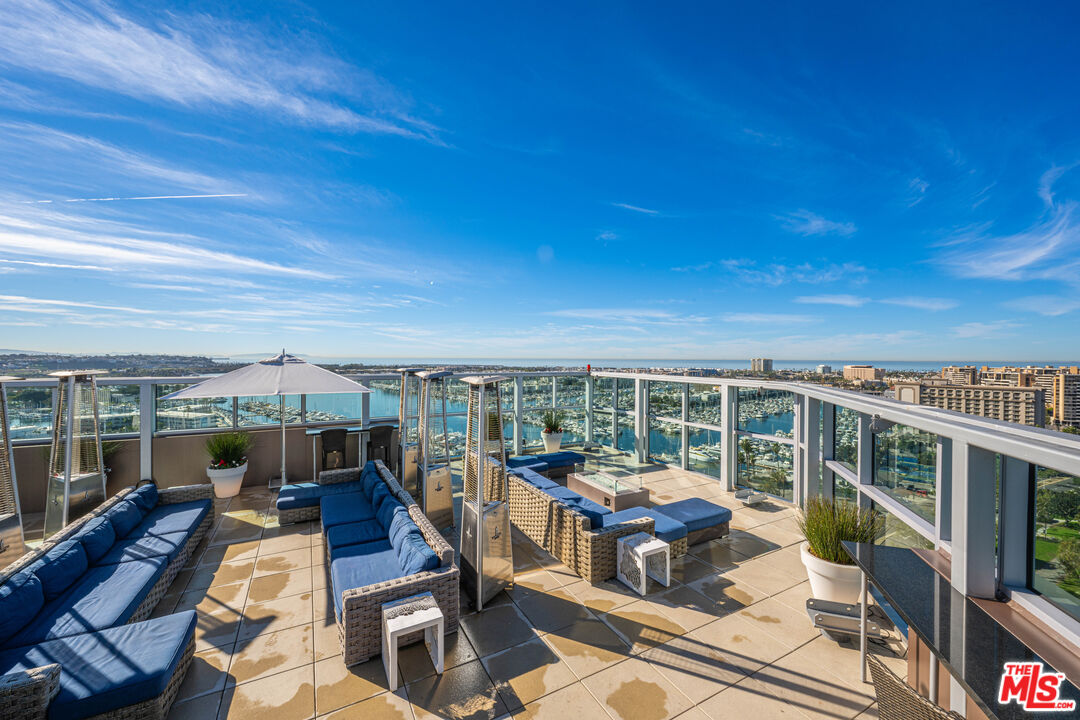 13700 Marina Pointe Drive, Unit 1007 Marina del Rey, CA 90292 - Photo 33 of 53 a view of a balcony with chairs and wooden floor