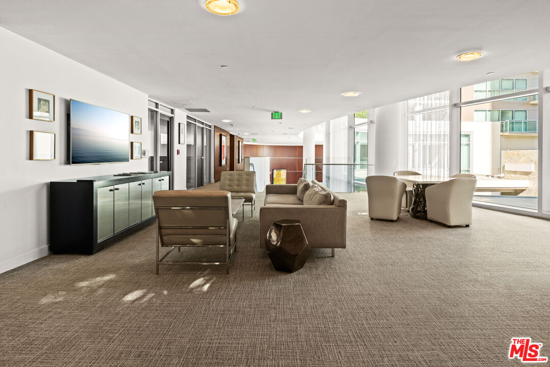 13700 Marina Pointe Drive, Unit 1007 Marina del Rey, CA 90292 - Photo 42 of 53 a living room with furniture and a flat screen tv
