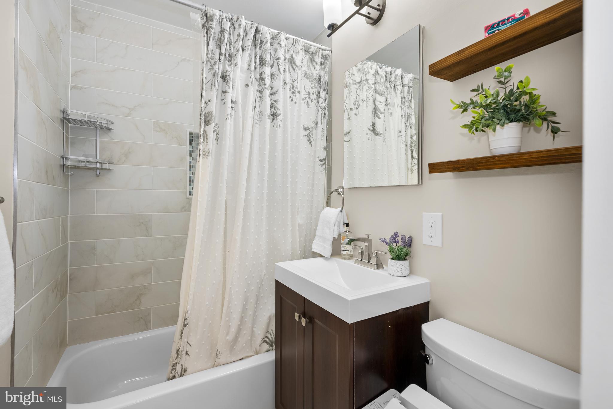 5 Webb Road Cabin John, MD 20818 - Photo 20 of 46 a bathroom with a sink a toilet and a bathtub