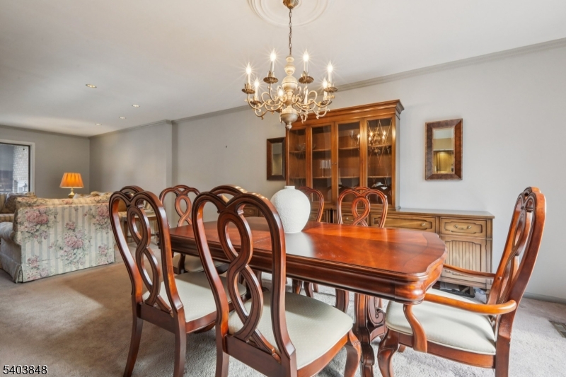 70 River Road, Unit C3 Clifton, NJ 07014 - Photo 11 of 35 a dining room with furniture and chandelier