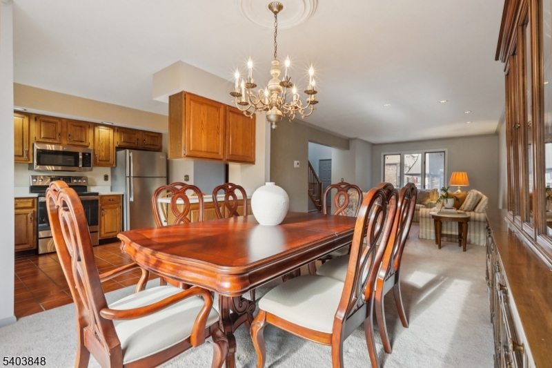 70 River Road, Unit C3 Clifton, NJ 07014 - Photo 12 of 35 a dining room with furniture and chandelier