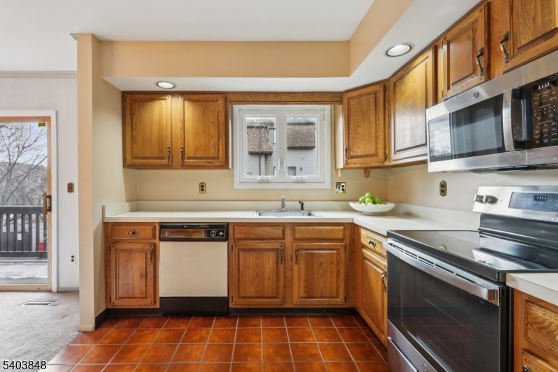70 River Road, Unit C3 Clifton, NJ 07014 - Photo 14 of 35 a kitchen with stainless steel appliances a sink stove and cabinets
