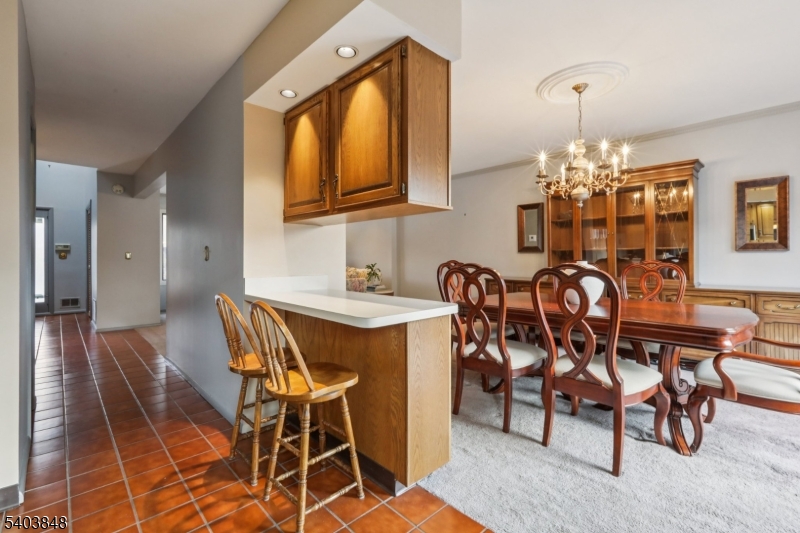 70 River Road, Unit C3 Clifton, NJ 07014 - Photo 15 of 35 a dining room with furniture and chandelier