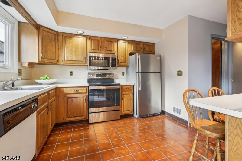 70 River Road, Unit C3 Clifton, NJ 07014 - Photo 16 of 35 a kitchen with stainless steel appliances a refrigerator sink and stove
