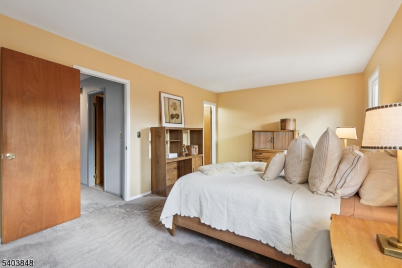 70 River Road, Unit C3 Clifton, NJ 07014 - Photo 26 of 35 a bedroom with a bed and a couch