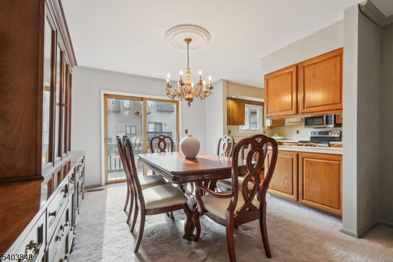 70 River Road, Unit C3 Clifton, NJ 07014 - Photo 10 of 35 a dining room with furniture a chandelier and window