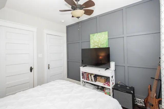 a bedroom with a bed and a flat screen tv