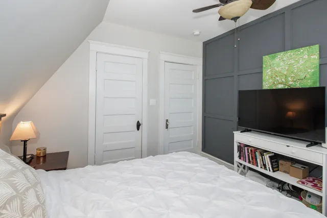 a bedroom with a bed and a flat screen tv