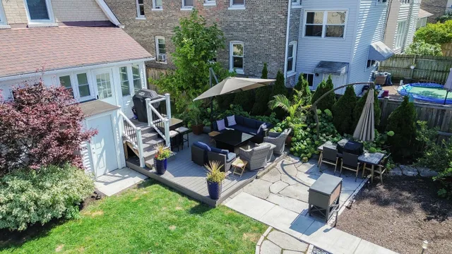a view of backyard with outdoor seating and plants