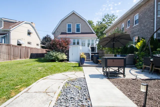 a front view of house with yard and outdoor seating