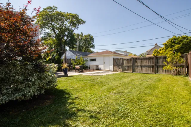 a front view of a house with swimming pool having outdoor seating