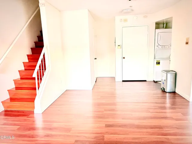 a kitchen with granite countertop wooden cabinets and a stove top oven