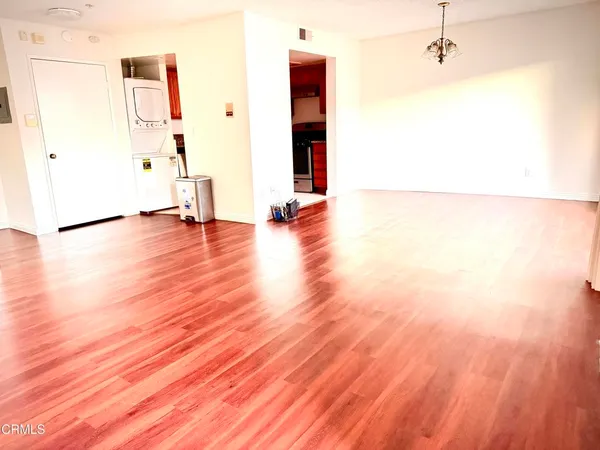 a view of empty room with wooden floor and stairs