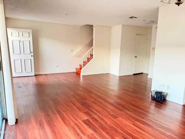 a view of a kitchen with wooden floor and cabinet