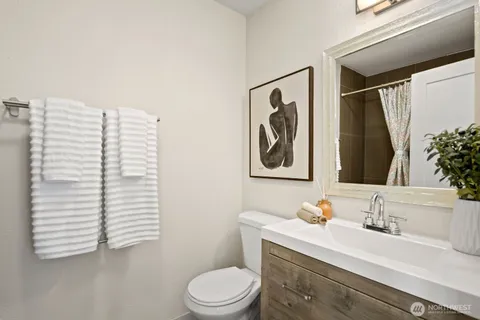 a bedroom with a bed and a painting on the wall