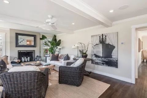 a kitchen with stainless steel appliances granite countertop a table chairs sink and cabinets