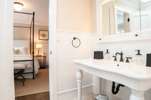 a bedroom with two beds and a large window