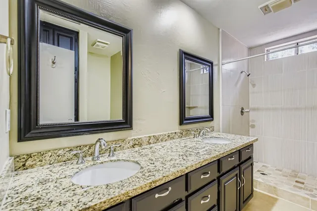 a bathroom with a granite countertop sink mirror and double
